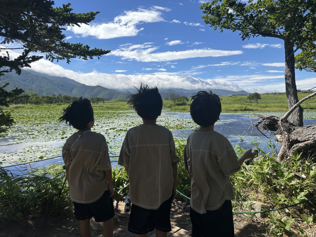 湖を眺める子どもたちの後ろ姿